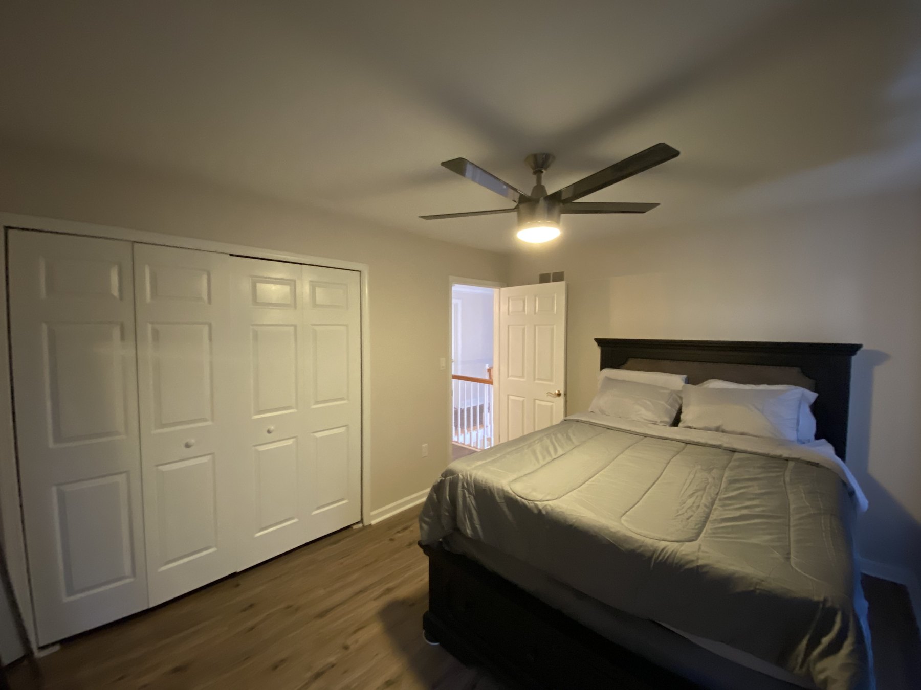 Finished residential bedroom with freshly painted walls, ceiling and trim